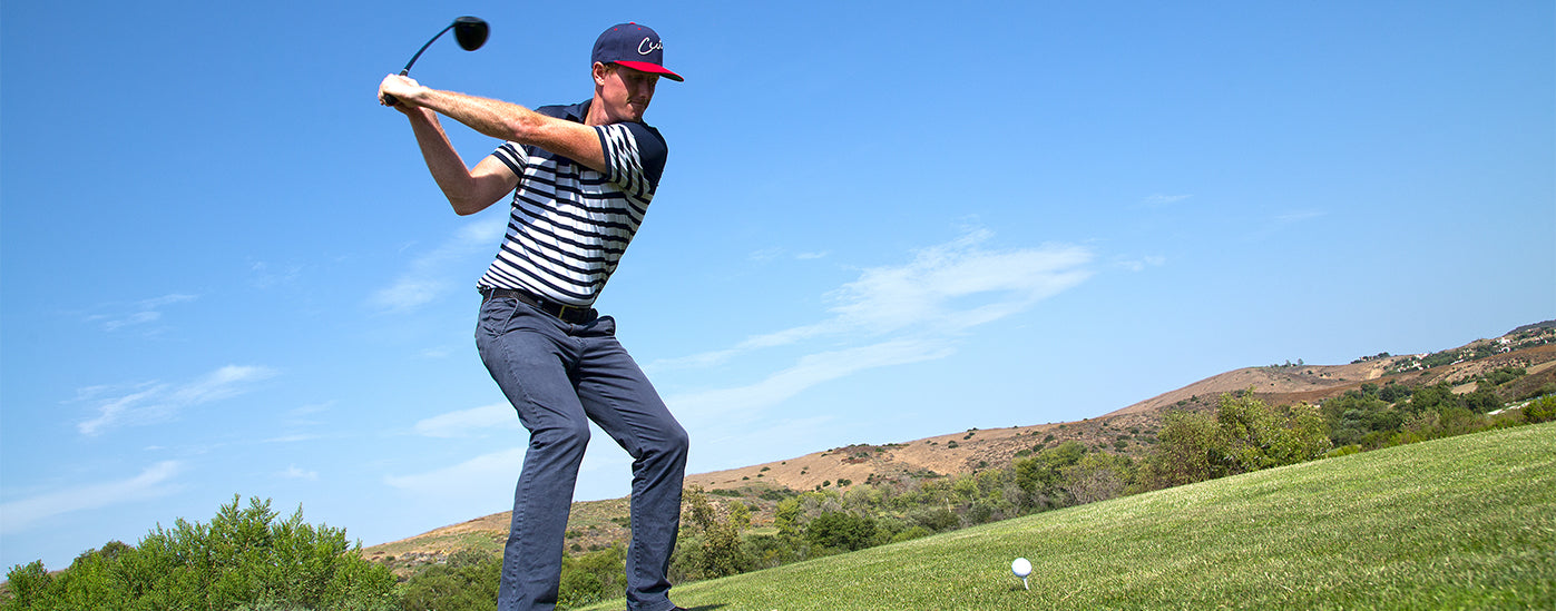 Golfer With a Cut Golf Hat On Driving Off the Tee