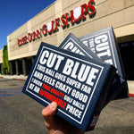 Hand Holding Three Cut Blue Dozen Boxes In Front of a Roger Dunn Golf Shop