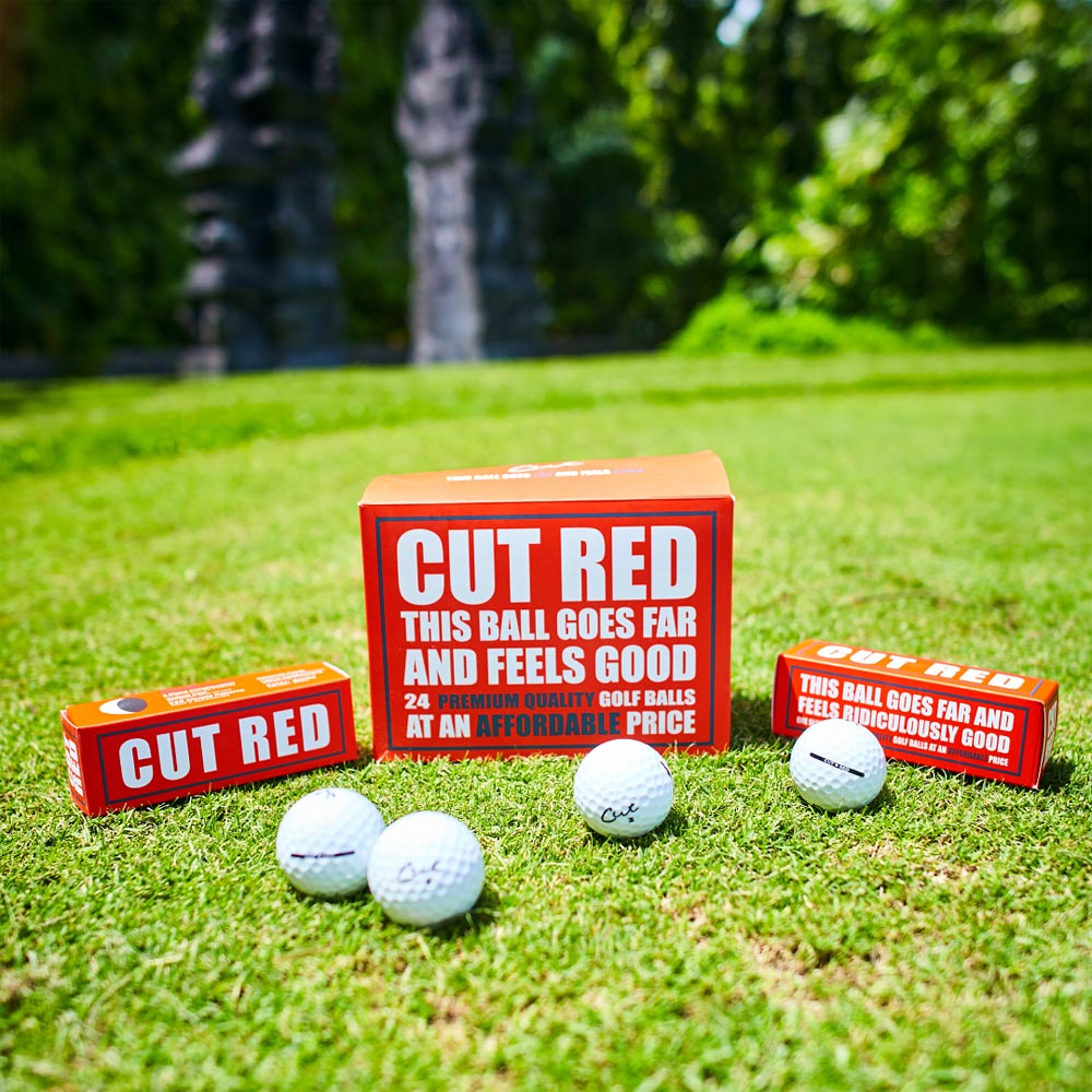 Cut Red Boxes of Sleeves and Dozen With Balls in Front On Tee Box