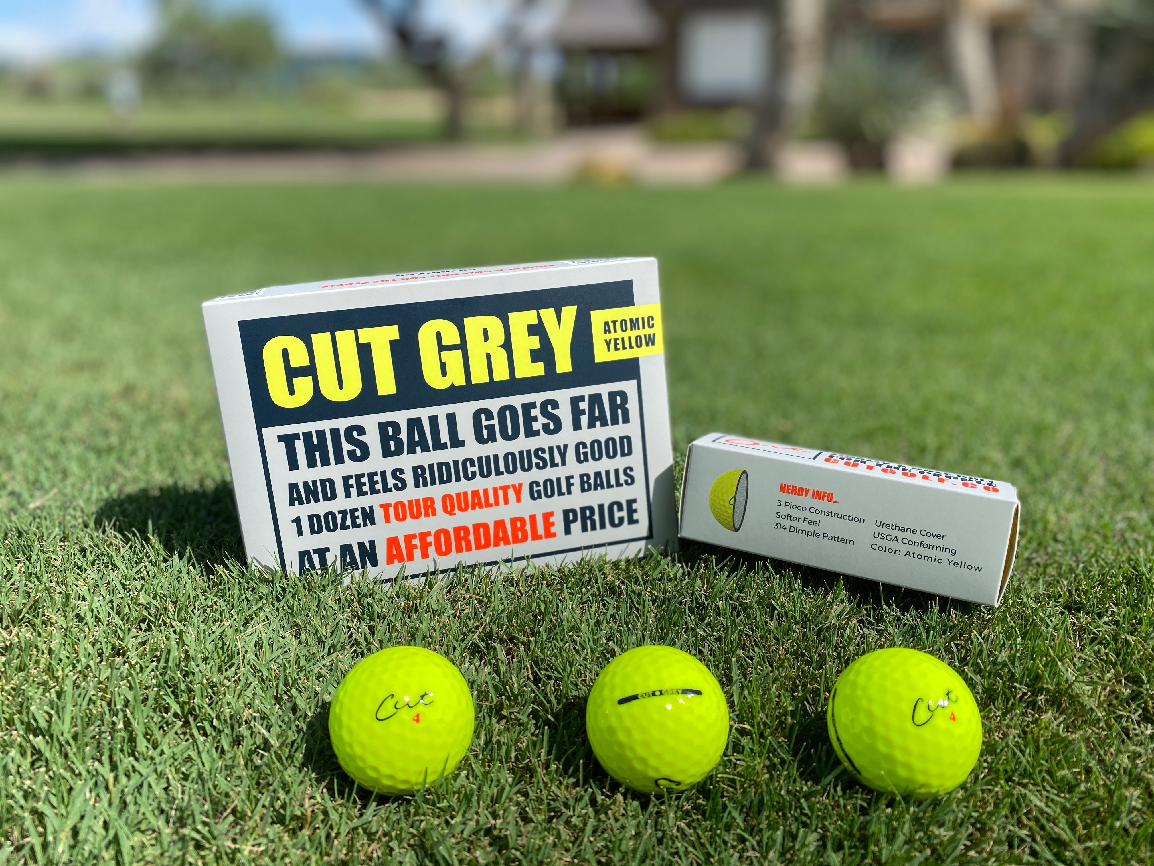 Box of Cut Grey Yellow Balls With an Open Sleeve Next To It and 3 Balls In Front Of It
