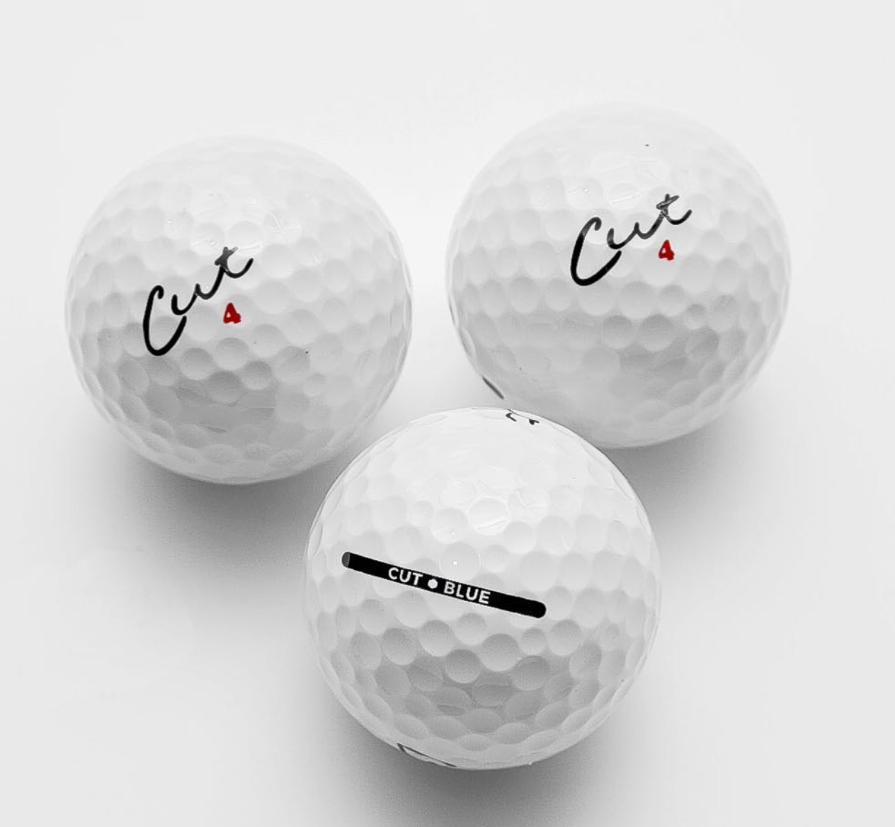 Three Cut Blue Golf Balls On a White Background