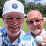 Smiling Golfer Holding a Cut DC Dual Core Ball With Partner