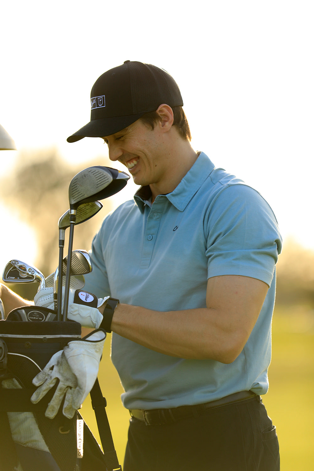 Golfer Tom Carey Smiling Wearing the Cut Golf Game Day Pale Blue Polo Shirt